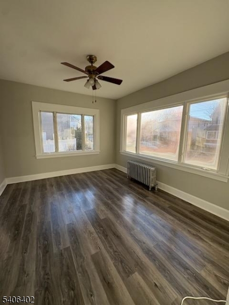 15 Ackerman Street, Unit 1 Bloomfield, NJ 07003 - Photo 3 of 23 a view of empty room with wooden floor and fan