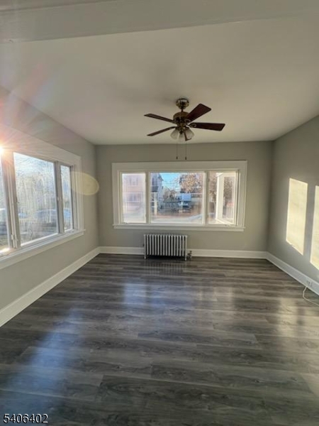 15 Ackerman Street, Unit 1 Bloomfield, NJ 07003 - Photo 5 of 23 a view of an empty room with wooden floor and a window