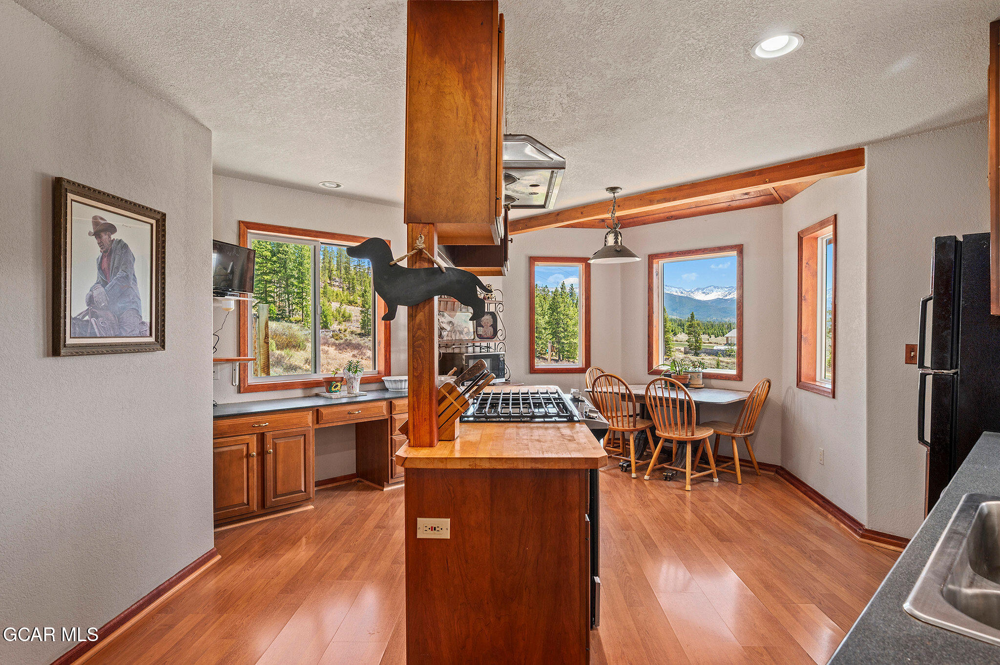 732 Gcr 8311/ Clayton Ranch Road Tabernash, CO 80478 - Photo 15 of 65 a dining room with furniture a large window and wooden floor
