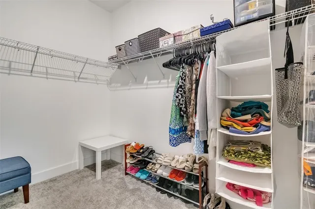 a utility room with lots of different colored cloths