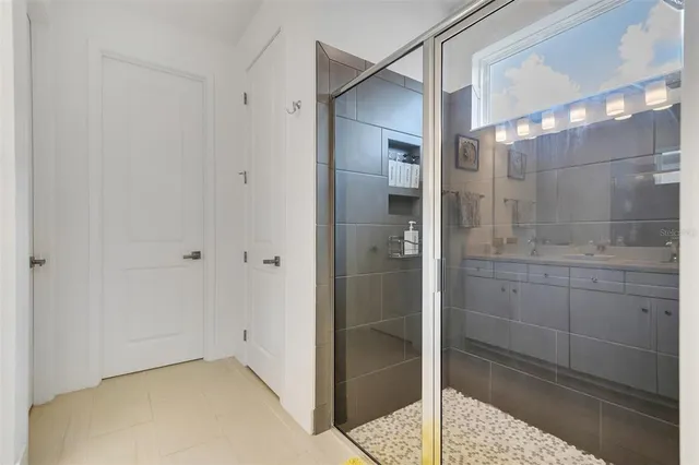 a bathroom with a shower and closet