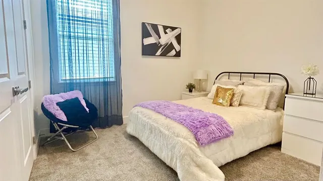 a bedroom with a bed and chair