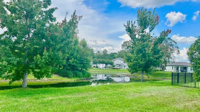 a view of a lake with a house in the background
