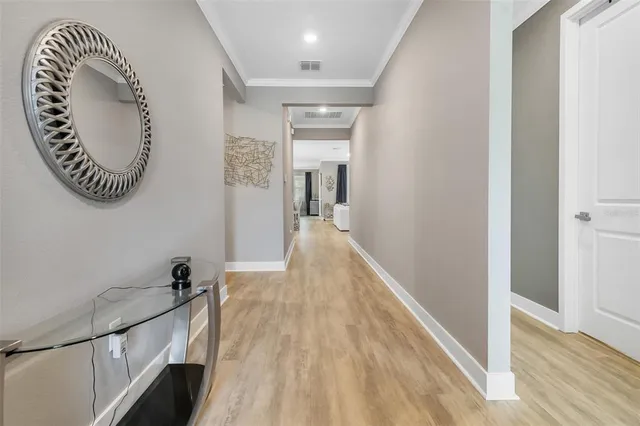 a view of a hallway with wooden floor