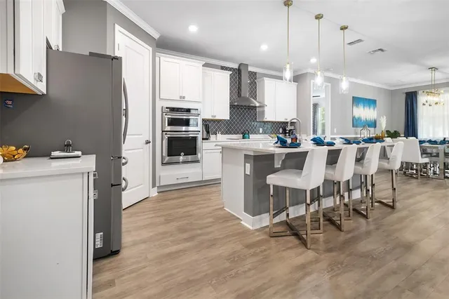 a large kitchen with a table and chairs