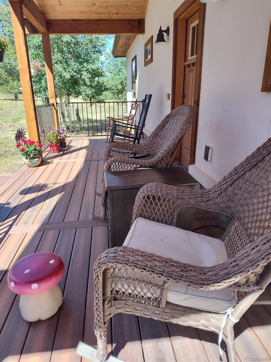 3561 Singletree Road Hartsel, CO 80449 - Photo 35 of 48 a living room with furniture and a floor to ceiling window