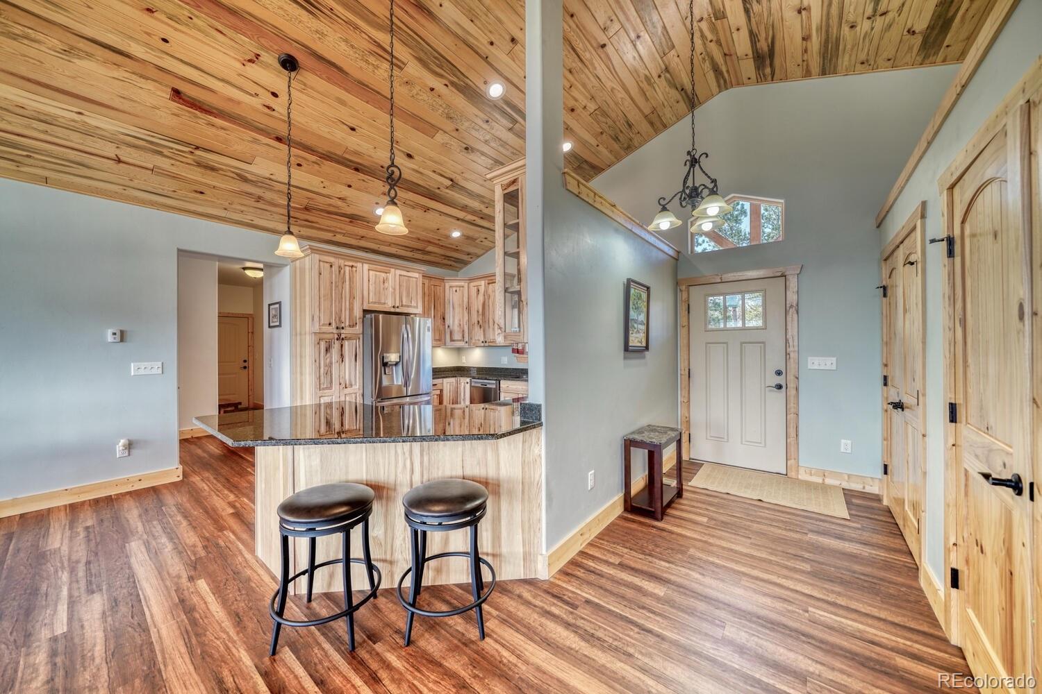 3561 Singletree Road Hartsel, CO 80449 - Photo 5 of 48 a view of a room with wooden floor and chandelier
