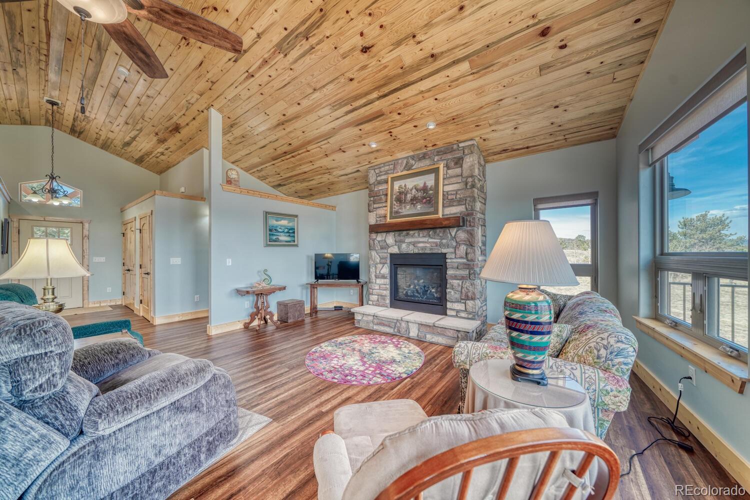 3561 Singletree Road Hartsel, CO 80449 - Photo 10 of 48 a living room with furniture and a fireplace