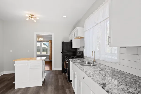 a kitchen with a stove a sink and a refrigerator