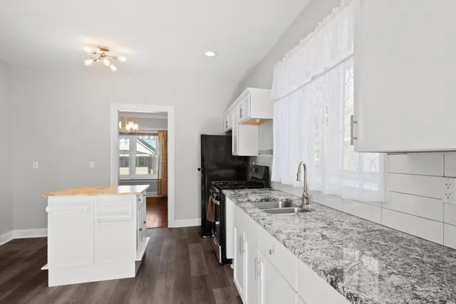 a kitchen with a stove a sink and a refrigerator