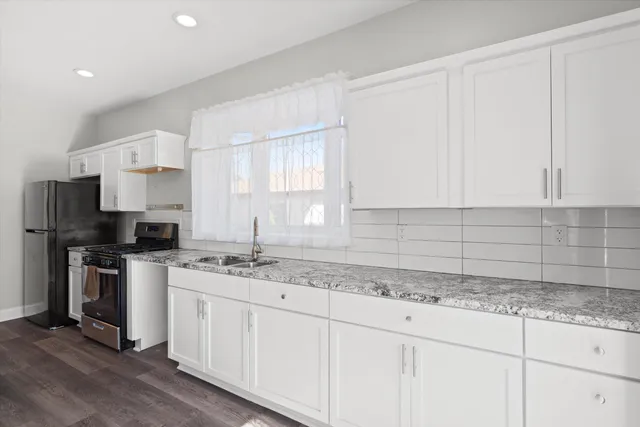 a kitchen with a sink stove and cabinets