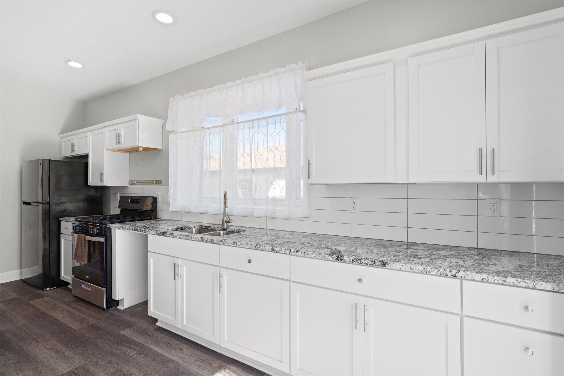 38 Condit Street Hammond, IN 46320 - Photo 13 of 36 a kitchen with a sink stove and cabinets