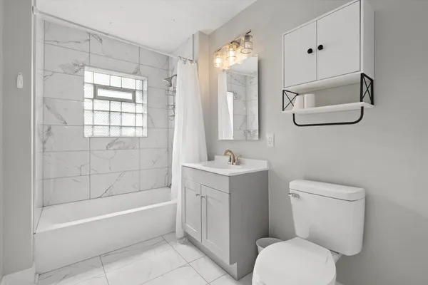 a bathroom with a toilet a sink and bathtub