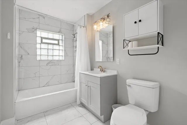 a bathroom with a toilet a sink and bathtub