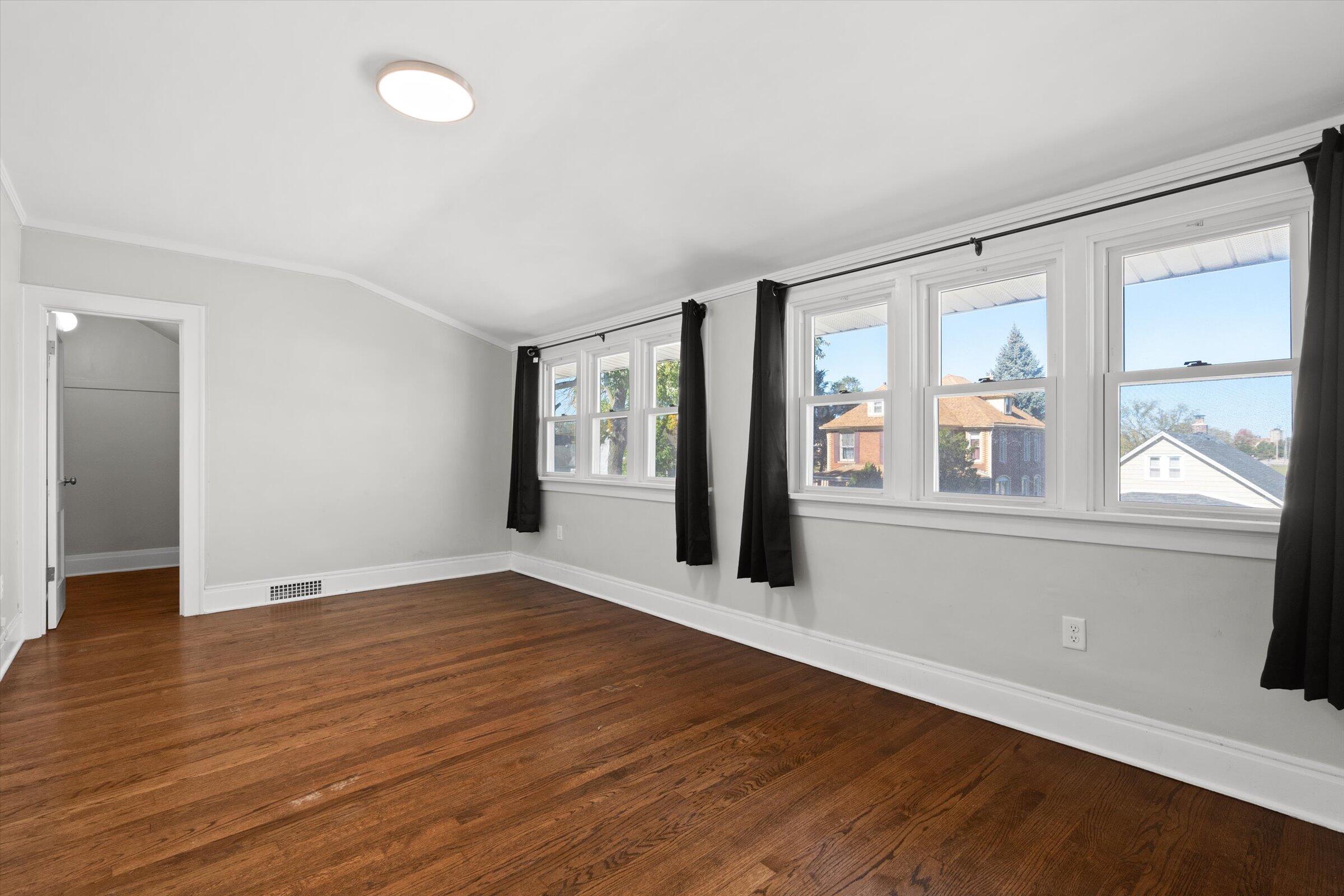 38 Condit Street Hammond, IN 46320 - Photo 21 of 36 an empty room with wooden floor and windows