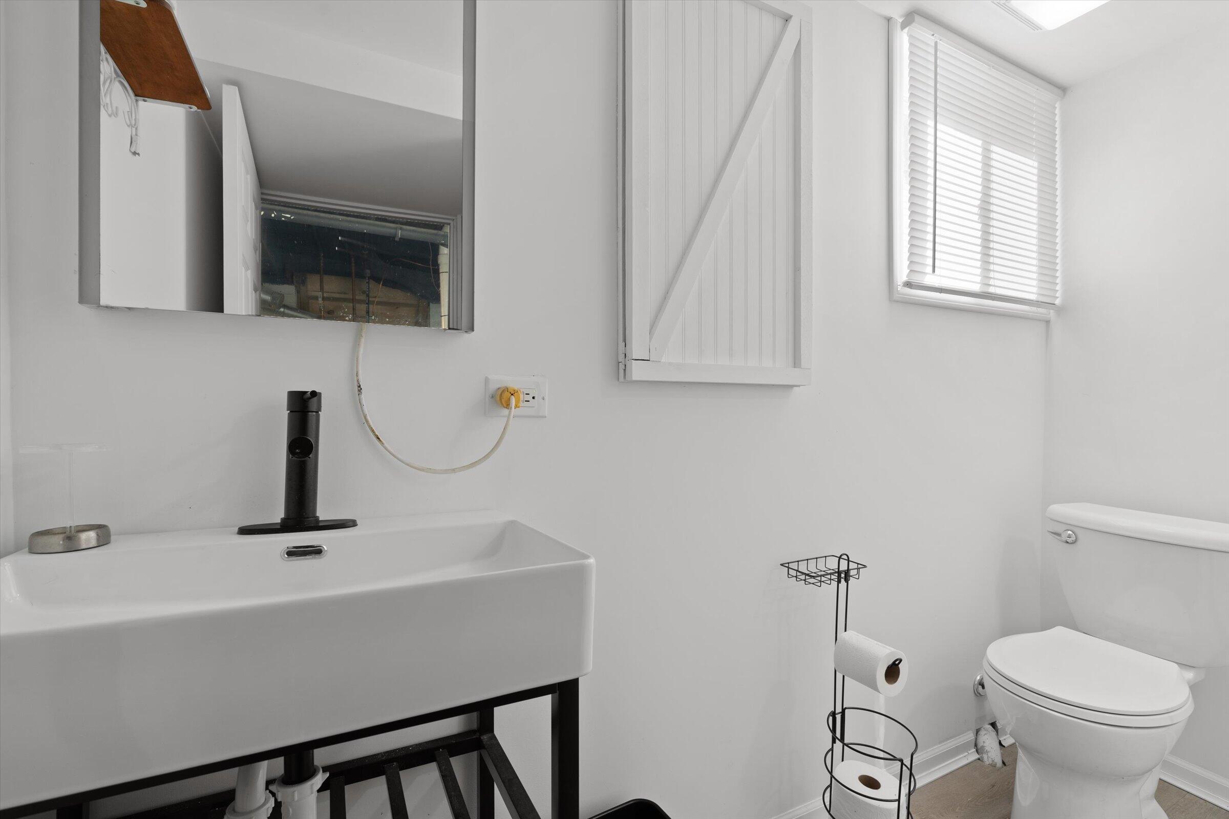 38 Condit Street Hammond, IN 46320 - Photo 31 of 36 a bathroom with a sink a toilet and mirror