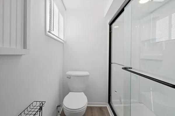a white toilet sitting next to a bathroom sink