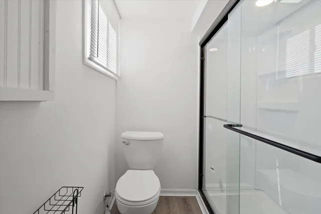 a white toilet sitting next to a bathroom sink