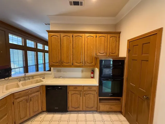 a bathroom with a granite countertop sink and washing machine