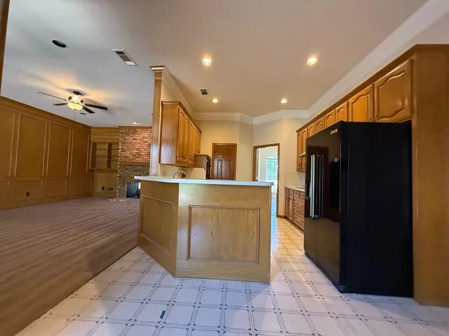 a view of kitchen with stainless steel appliances granite countertop a refrigerator and a sink