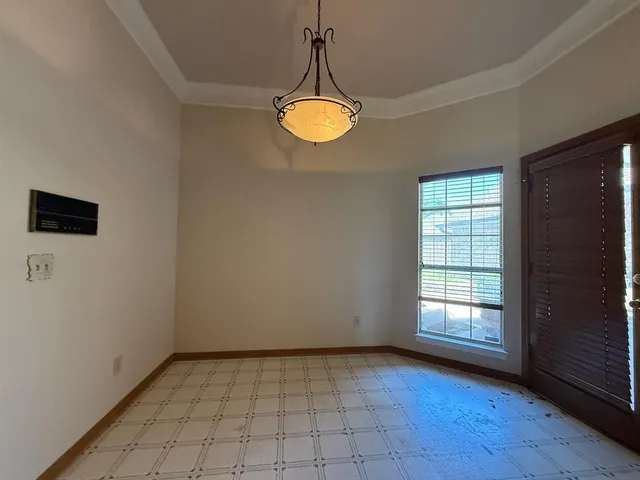 an empty room with a window and wooden floor