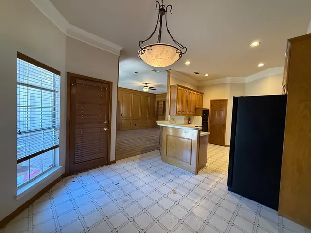 a view of a kitchen with a sink and refrigerator