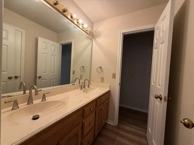 a bathroom with a sink double vanity and a mirror