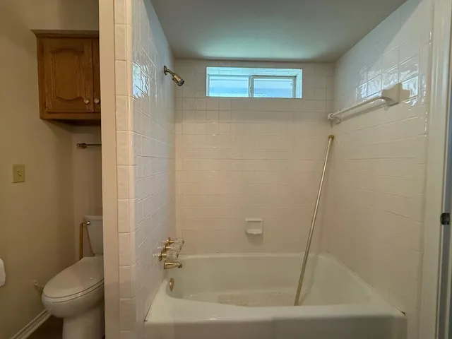 a bathroom with a bathtub and a toilet