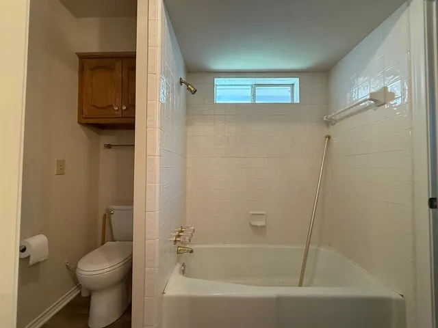 a bathroom with a toilet and a bathtub
