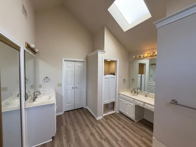 a bathroom with a double vanity sink a mirror and shower