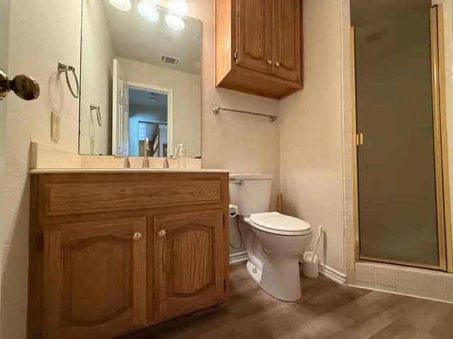 a bathroom with a sink a toilet and mirror