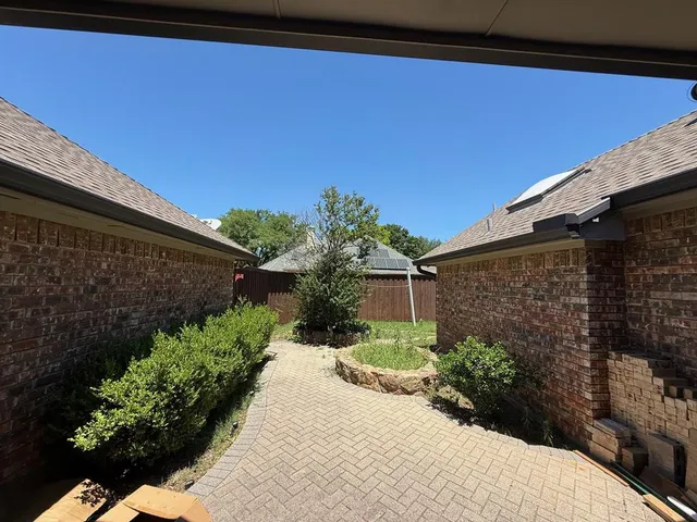 a view of a backyard with potted plants