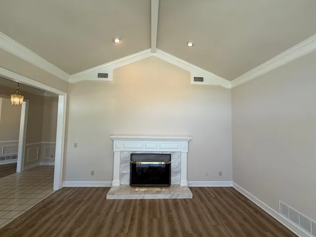 wooden floor in an empty room with a fireplace