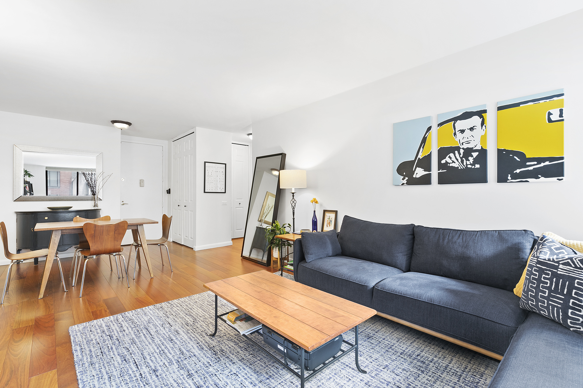 330 East 75th Street, Unit 3F Manhattan, NY 10021 - Photo 2 of 6 a living room with furniture a rug and a floor to ceiling window