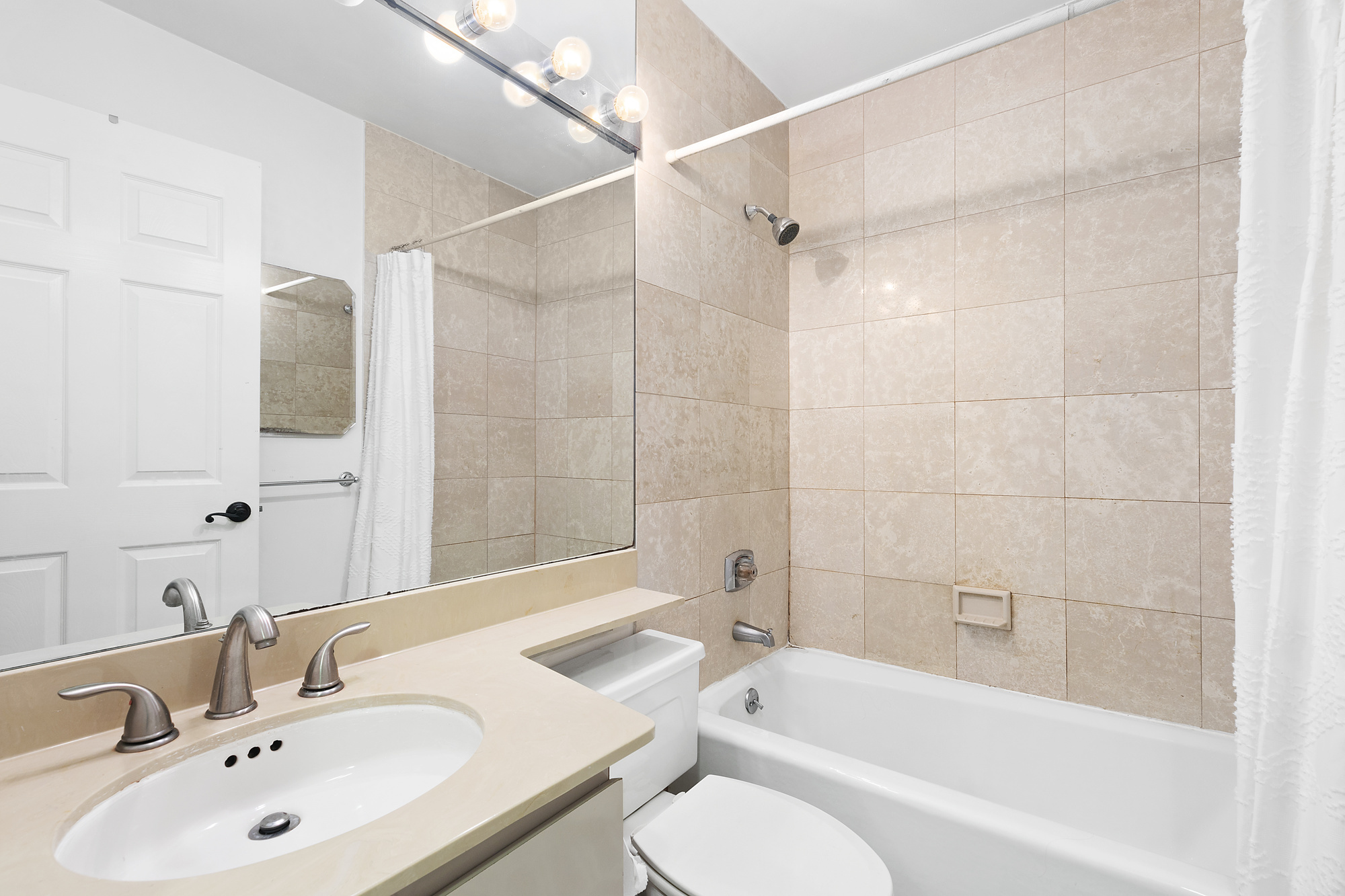 330 East 75th Street, Unit 3F Manhattan, NY 10021 - Photo 5 of 6 a bathroom with a sink toilet and shower