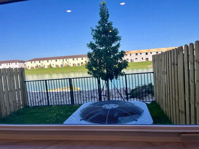 a view of a backyard with wooden fence