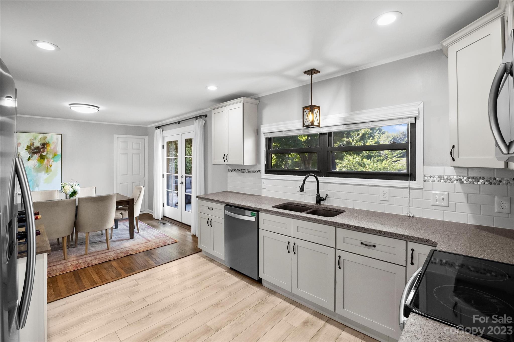 714 Brockbank Road Charlotte, NC 28209 - Photo 12 of 38 a kitchen with a sink cabinets and window