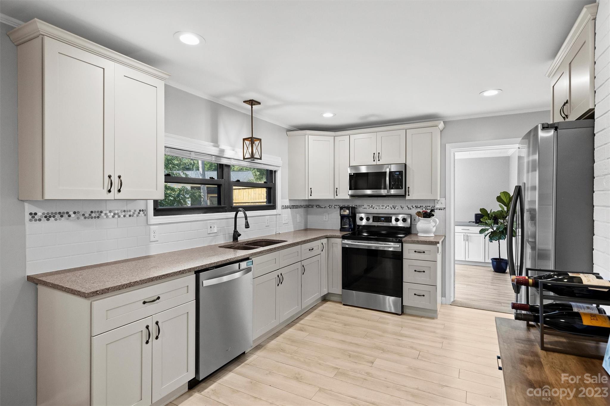 714 Brockbank Road Charlotte, NC 28209 - Photo 14 of 38 a kitchen with stainless steel appliances granite countertop a stove top oven a sink dishwasher a refrigerator and a oven with wooden floor