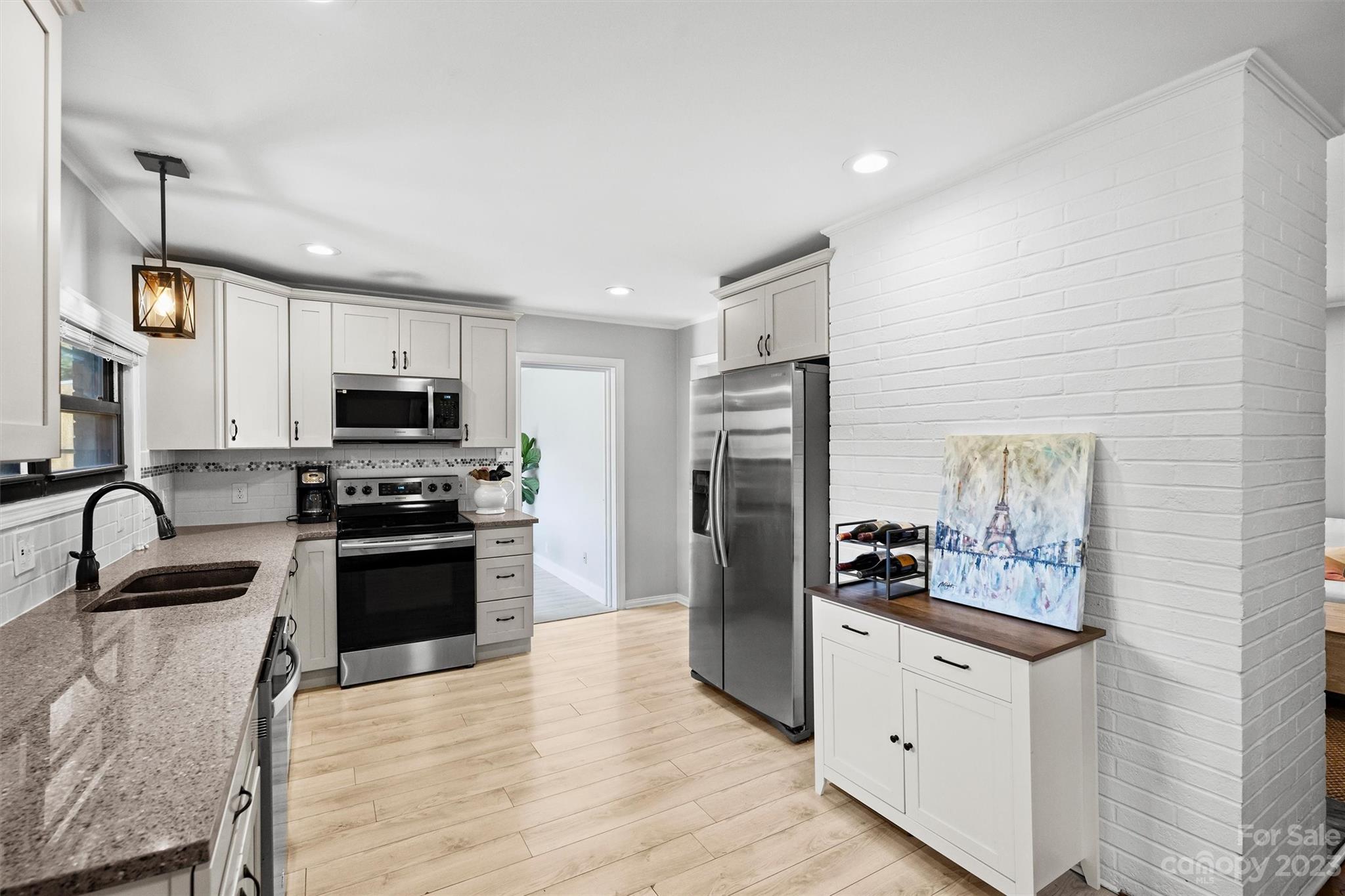 714 Brockbank Road Charlotte, NC 28209 - Photo 15 of 38 a kitchen with stainless steel appliances granite countertop a refrigerator and a stove top oven