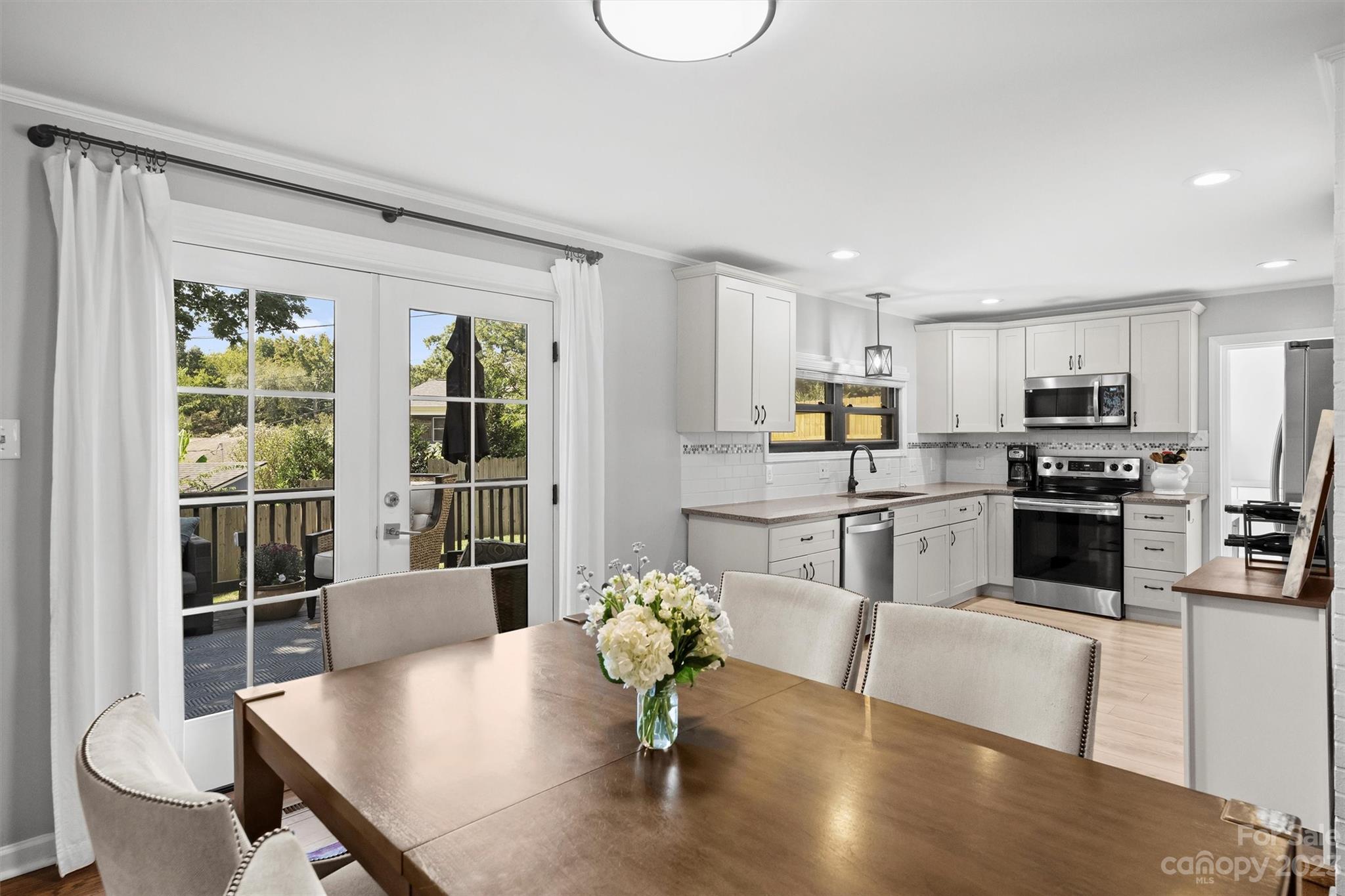 714 Brockbank Road Charlotte, NC 28209 - Photo 18 of 38 a kitchen with white cabinets and stainless steel appliances