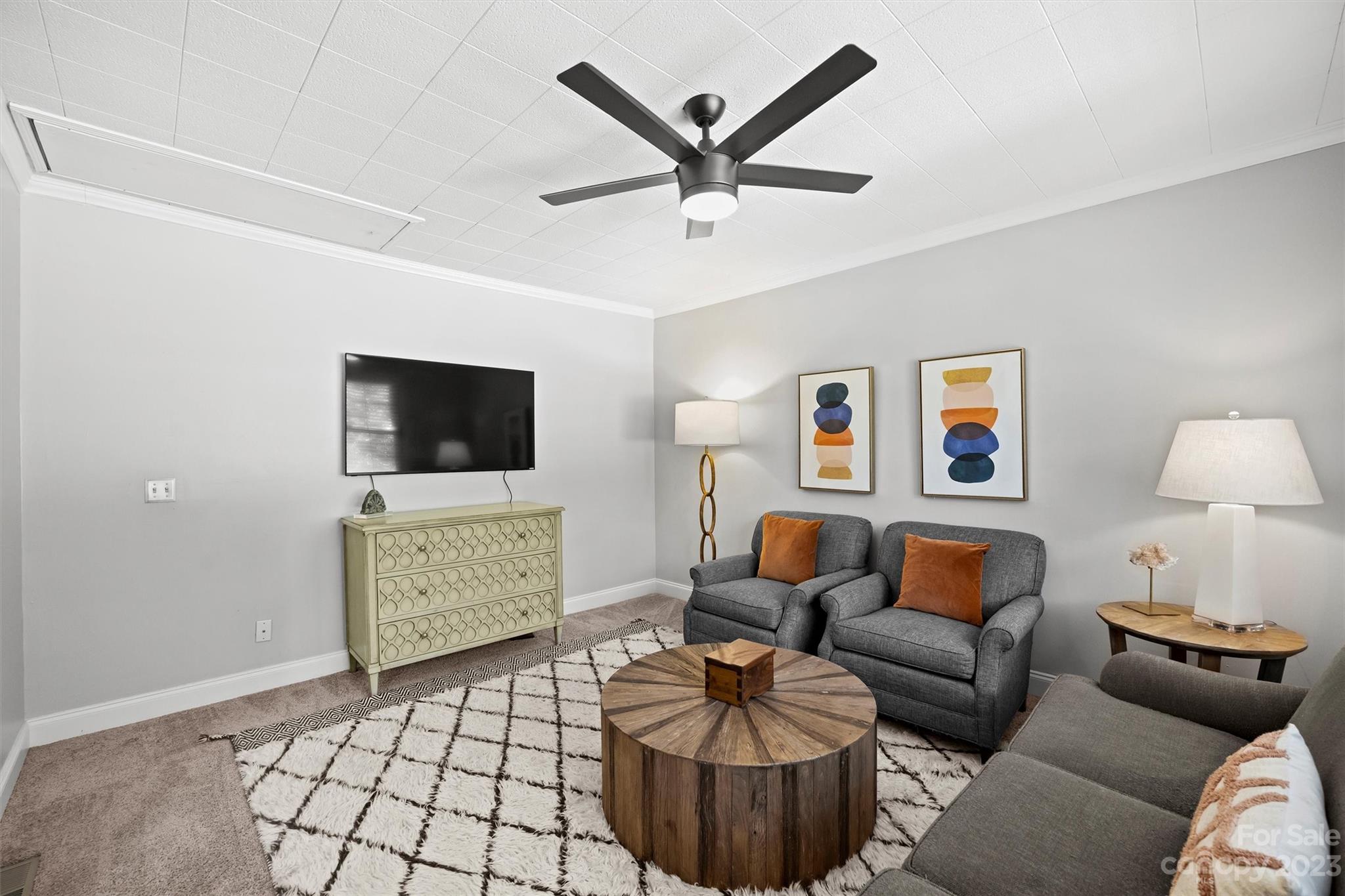 714 Brockbank Road Charlotte, NC 28209 - Photo 23 of 38 a living room with furniture and a flat screen tv