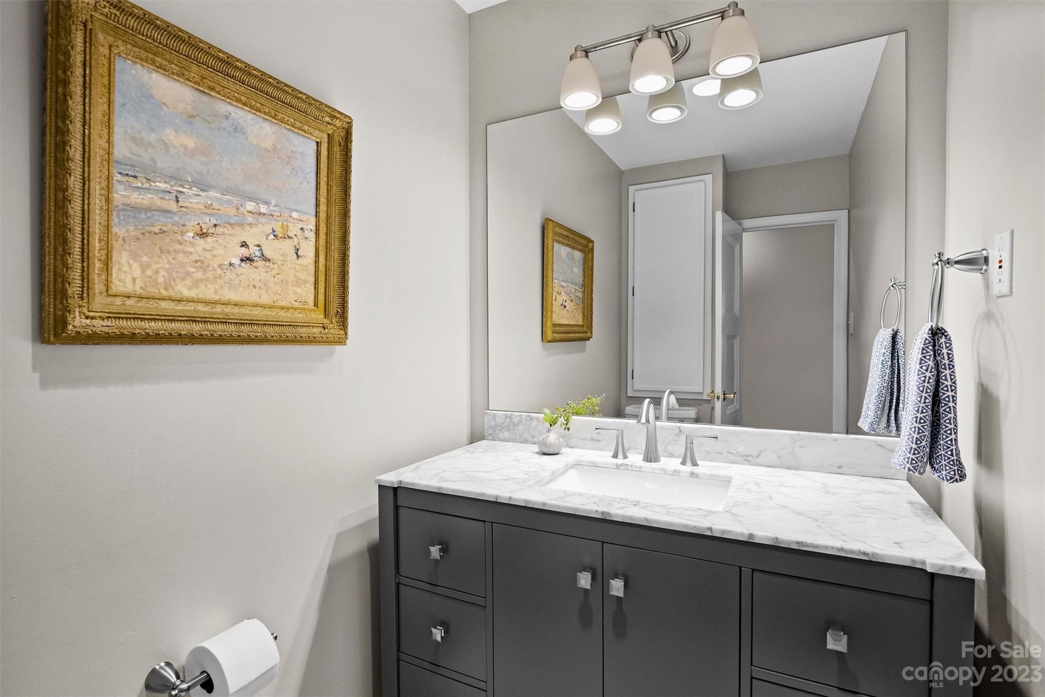 714 Brockbank Road Charlotte, NC 28209 - Photo 24 of 38 a bathroom with a granite countertop sink a large mirror and vanity