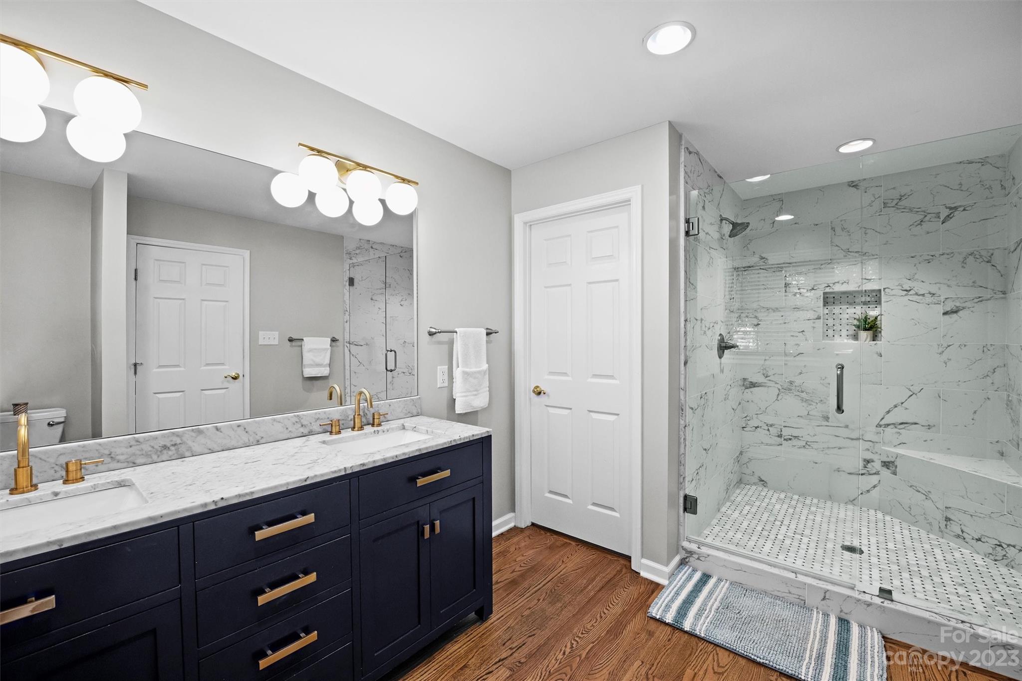 714 Brockbank Road Charlotte, NC 28209 - Photo 27 of 38 a bathroom with a sink a toilet and shower