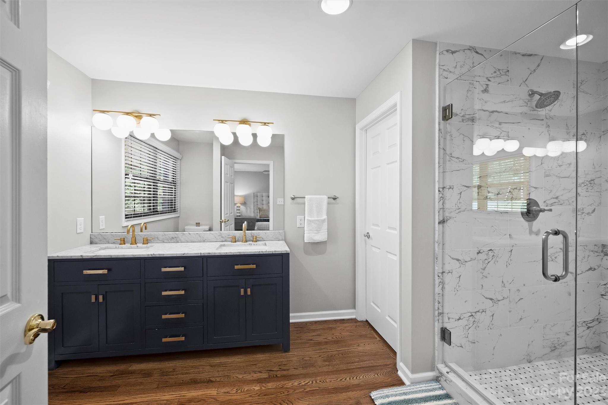714 Brockbank Road Charlotte, NC 28209 - Photo 28 of 38 a bathroom with a double vanity sink mirror and shower