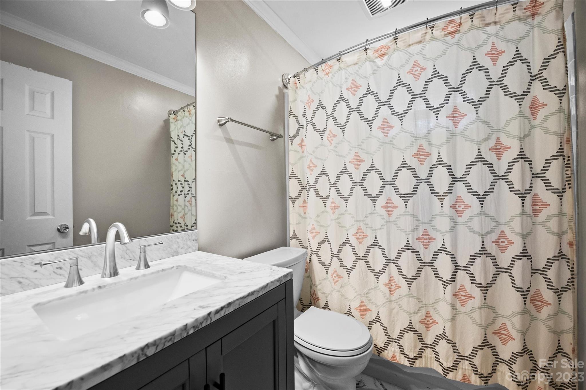 714 Brockbank Road Charlotte, NC 28209 - Photo 32 of 38 a bathroom with a granite countertop sink and a mirror