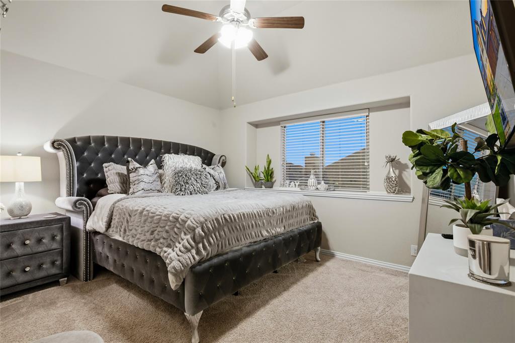 1802 Roundtree Road Forney, TX 75126 - Photo 35 of 39 a bedroom with a large bed and a potted plant