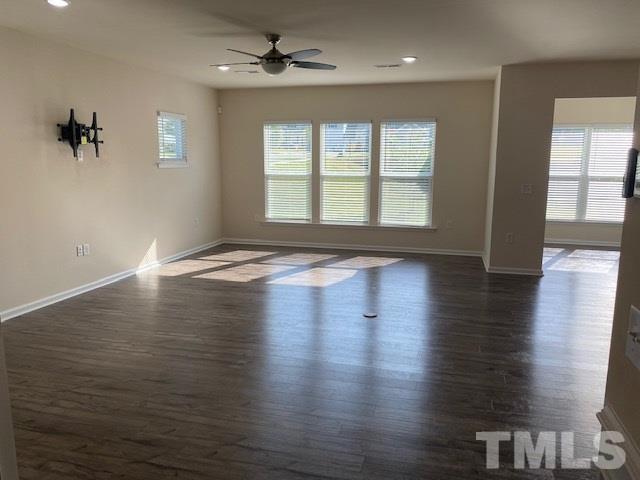 674 Brook Pine Trail Apex, NC 27523 - Photo 11 of 30 a view of an empty room with wooden floor and a window
