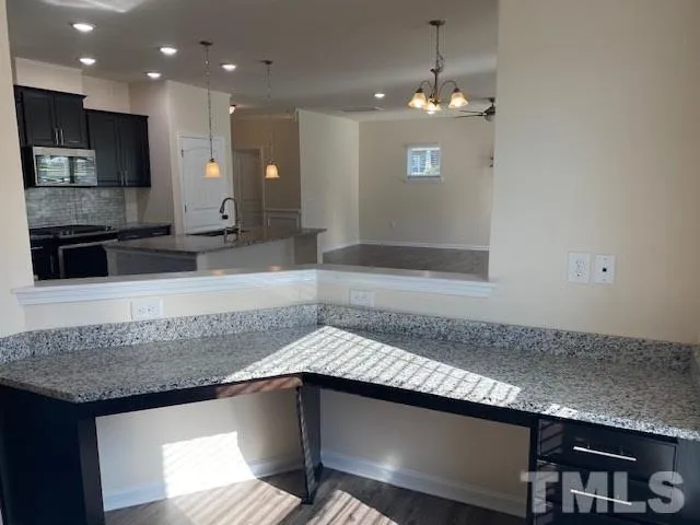a kitchen with granite countertop a sink and cabinets