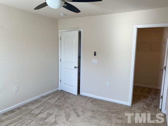 674 Brook Pine Trail Apex, NC 27523 - Photo 17 of 30 an empty room with closet and a chandelier fan