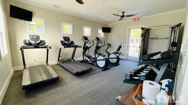 a room with gym equipment and a flat screen tv